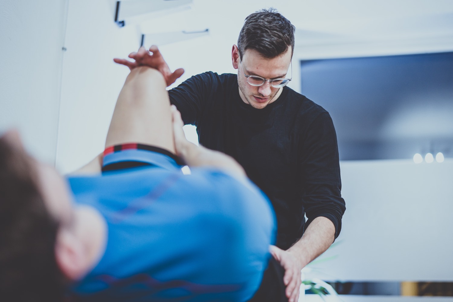 Checking a rider’s knee position during a bike fitting