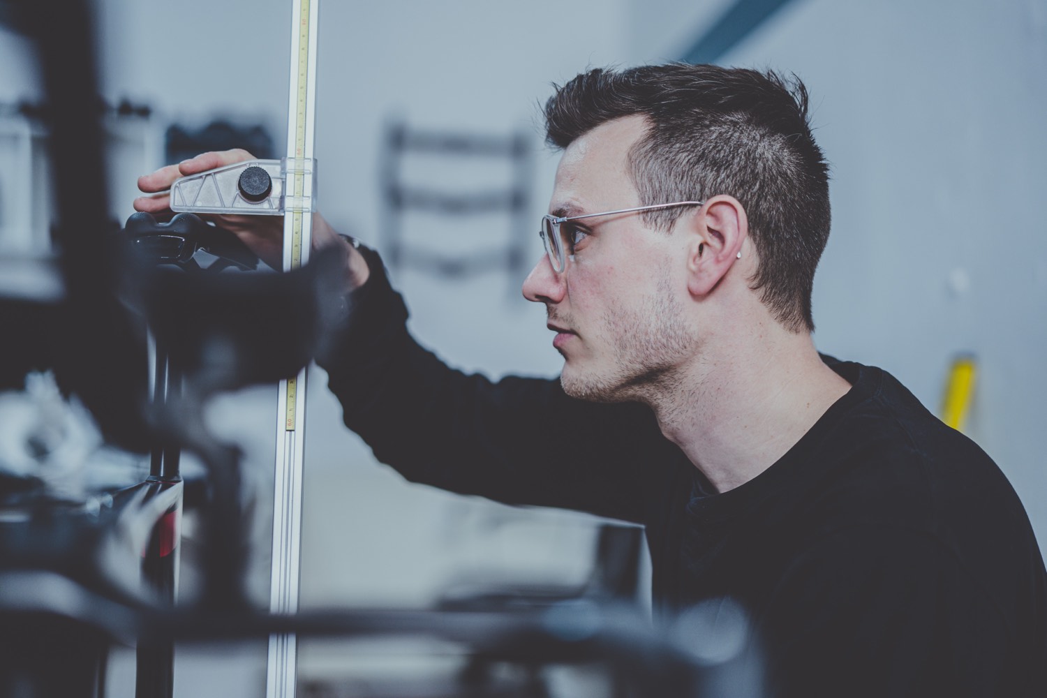Measuring a bike position with a ruler during a fitting